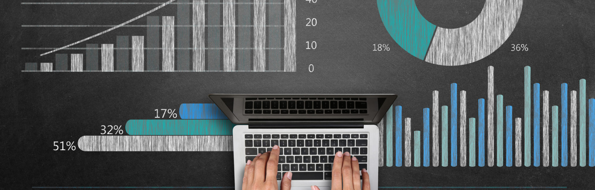 Close-up of a women hand typing laptop keypad from representing the concept of business graph in front of blackboard.