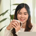 Asian female professional using laptop to manage hybrid mail automation online