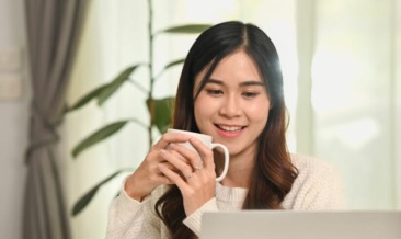 Asian female professional using laptop to manage hybrid mail automation online