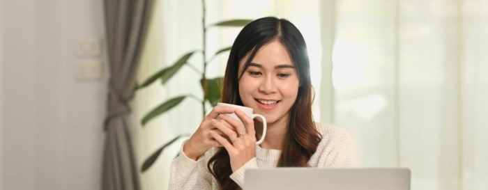 Asian female professional using laptop to manage hybrid mail automation online