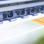 A printer printing a sign post for a business