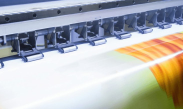 A printer printing a sign post for a business