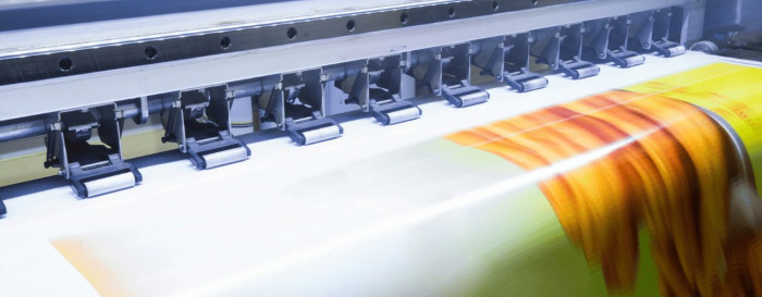 A printer printing a sign post for a business