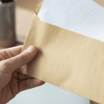 A person getting a letter from an envelope at the office